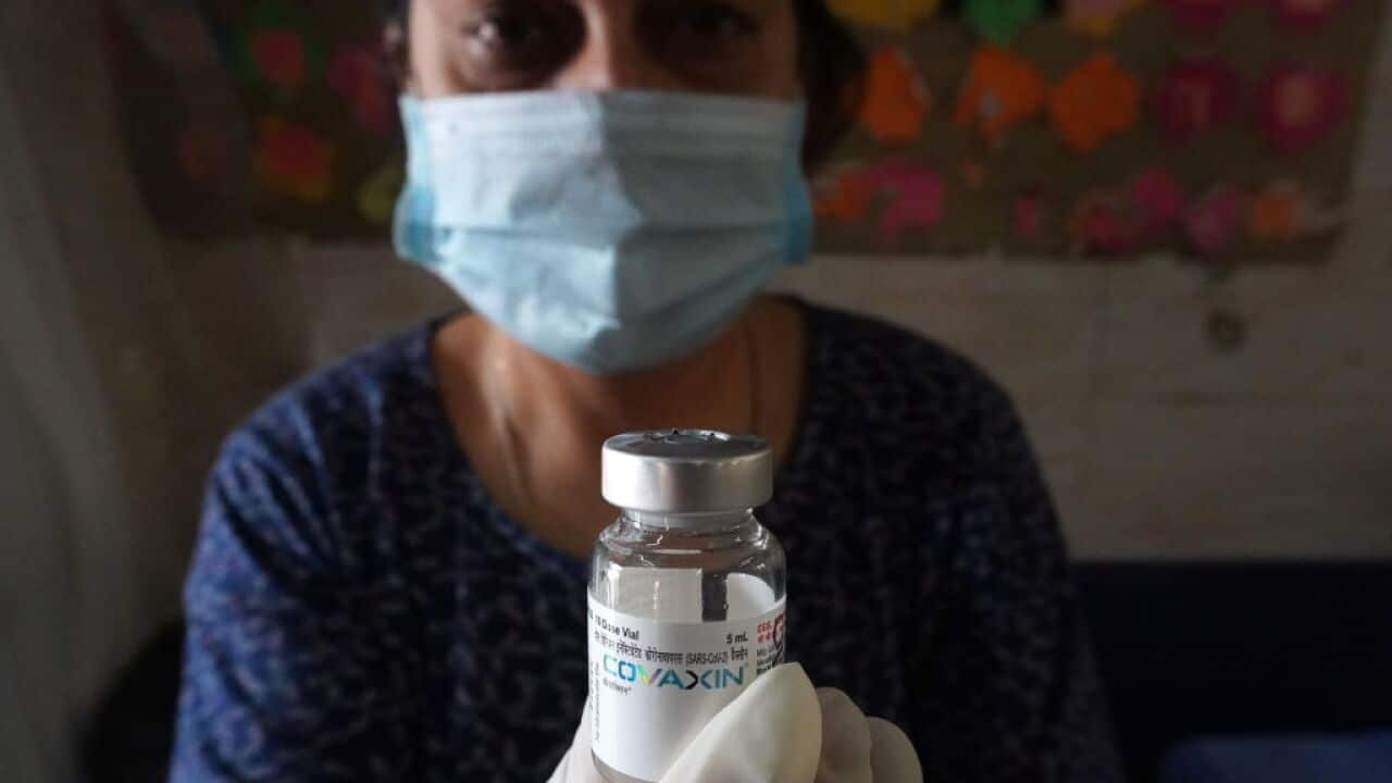 A health worker shows a vial of Covaxin during a vaccination drive against coronavirus inside a school in New Delhi, India on 20 October, 2021. 
