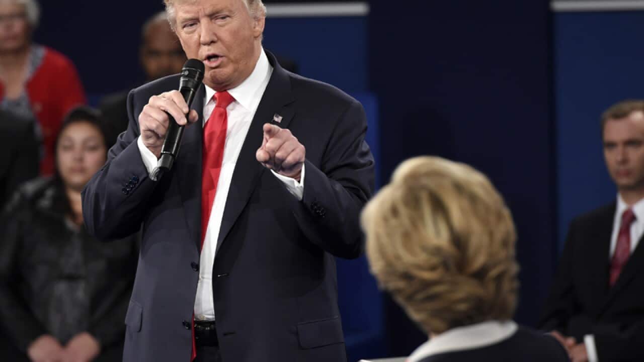 Donald Trump points at Democratic presidential nominee Hillary Clinton
