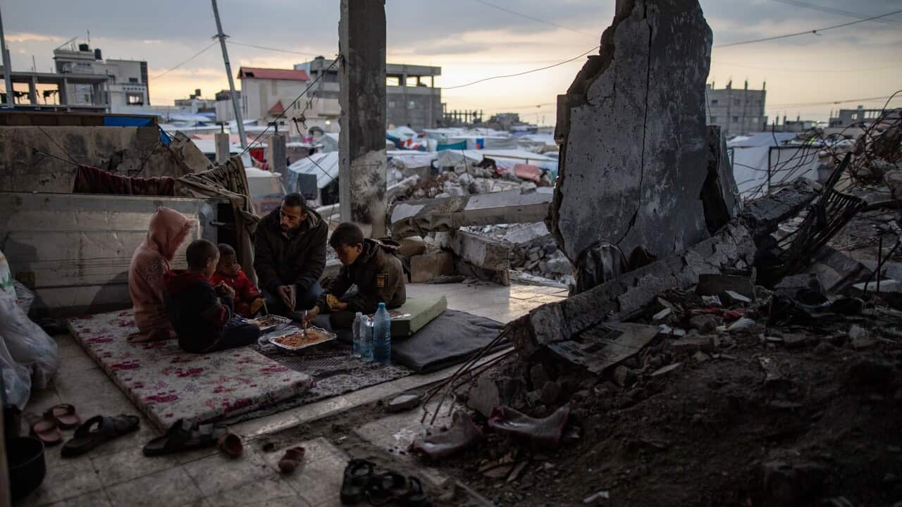 Muhammad al-Durra and his family take shelter in a destroyed house, in Rafah, southern Gaza Strip_AAP