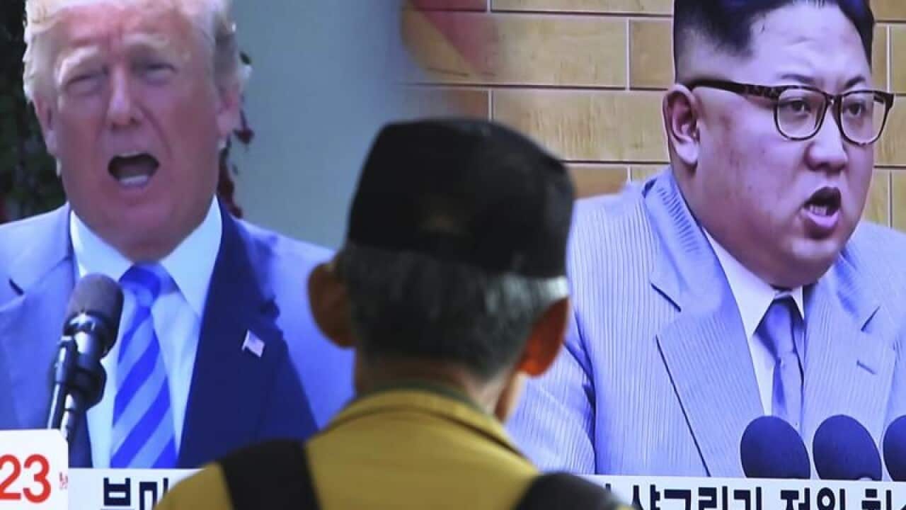 A man watches an announcement of the US-North Korea summit
