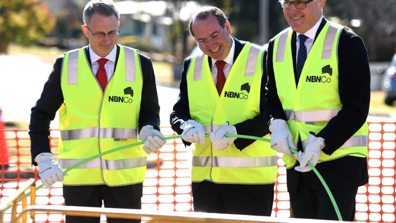Malcolm Turnbull (R) lends a hand rolling out NBN fibre