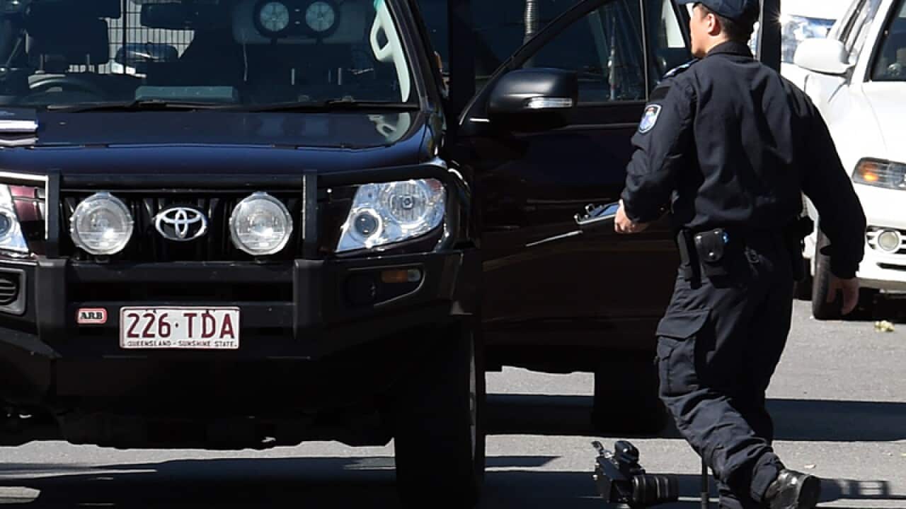 A police bomb squad officer retrieves a robot