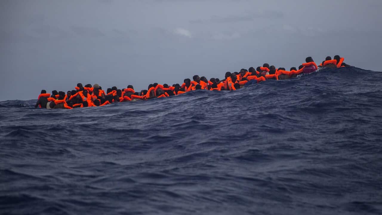 Migrants wait to be rescued by aid workers of Spanish NGO Proactiva Open Arms in the Mediterranean Sea, about 15 miles north of Sabratha in Libya.