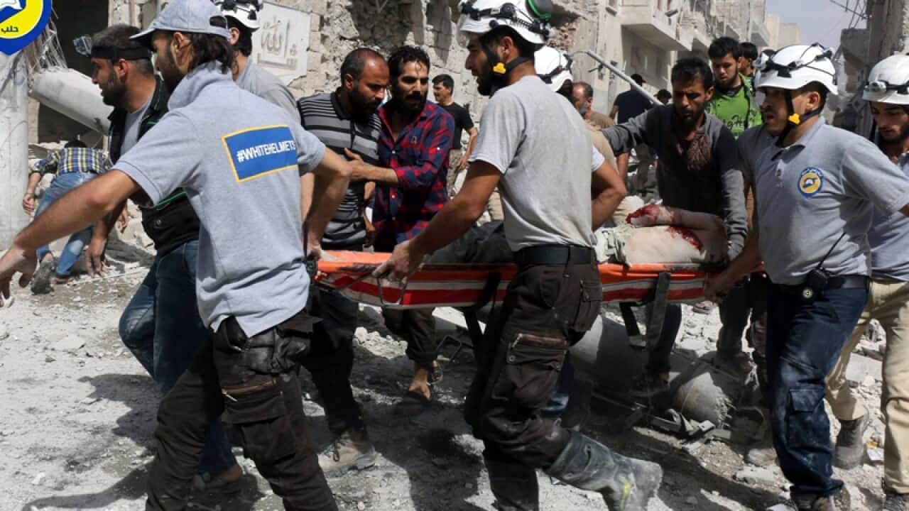 Rescue workers at the site of an airstrike in eastern Aleppo