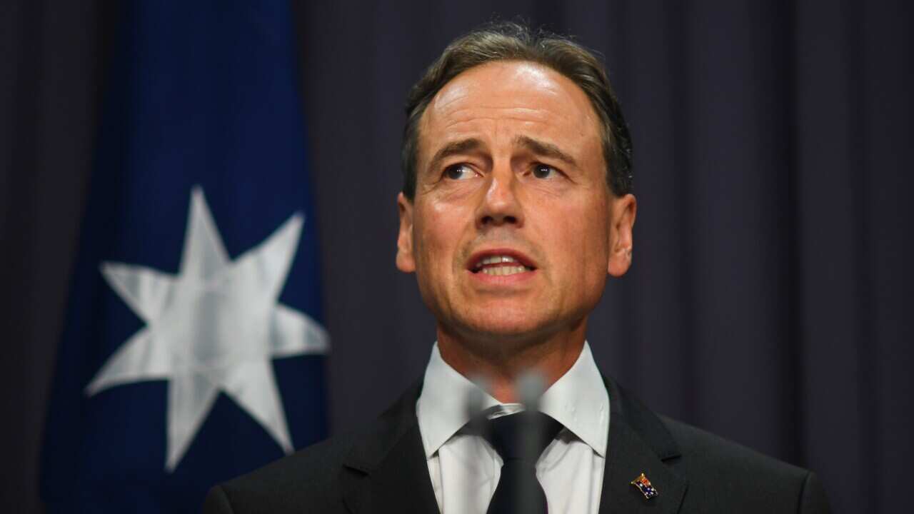 Health Minister Greg Hunt talks to the media.