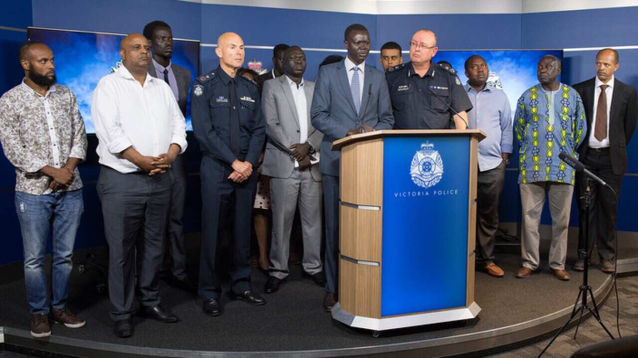 An African community leader Kot Monoah speaks to the media alongside and Victorian Chief Police Commissioner Graham Ashton during a press conference in Melbourne, Wednesday, January 10, 2018. (AAP Image/Ellen Smith) NO ARCHIVING