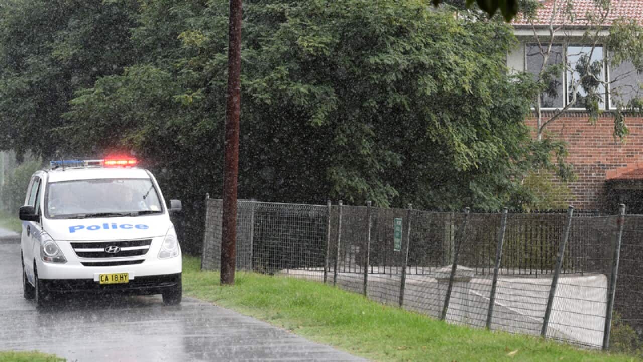 Female police officers with their male collegues stock