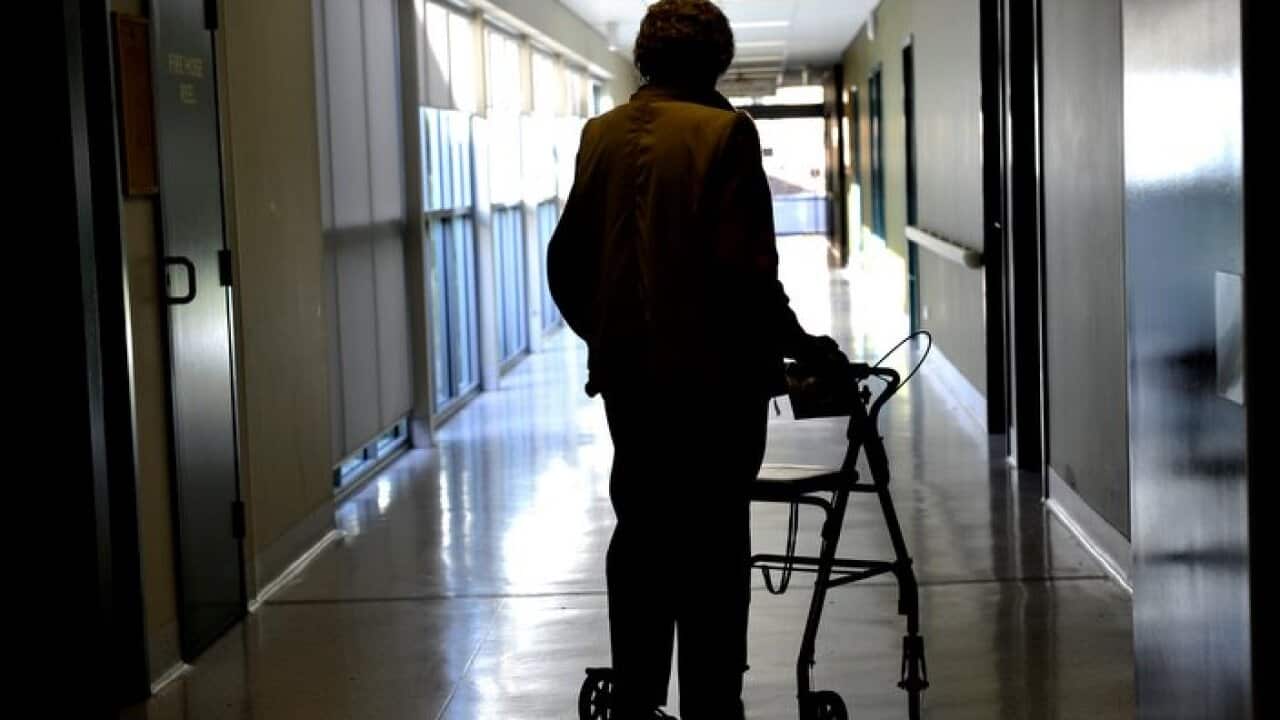 A woman uses a walker to assist her mobility in Canberra, Friday, May 24, 2013. (AAP Image/Alan Porritt) NO ARCHIVING