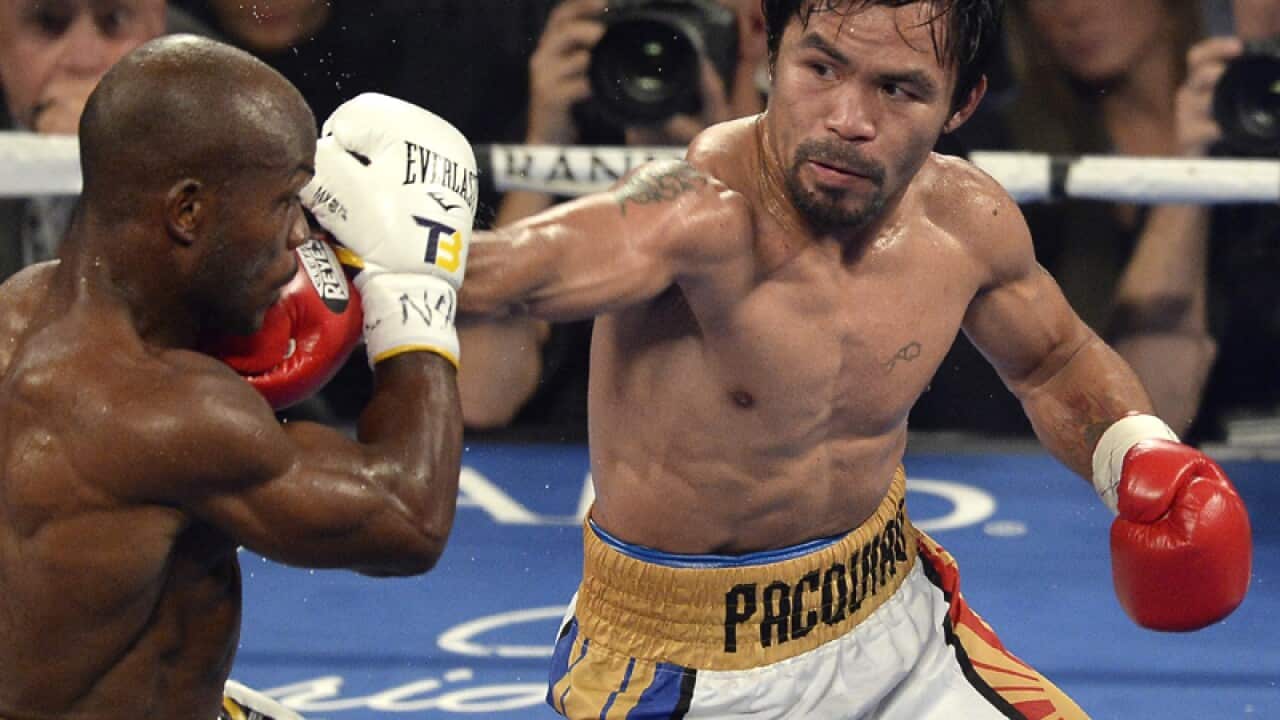 Manny Pacquiao (R) in action against Timothy Bradley (L)