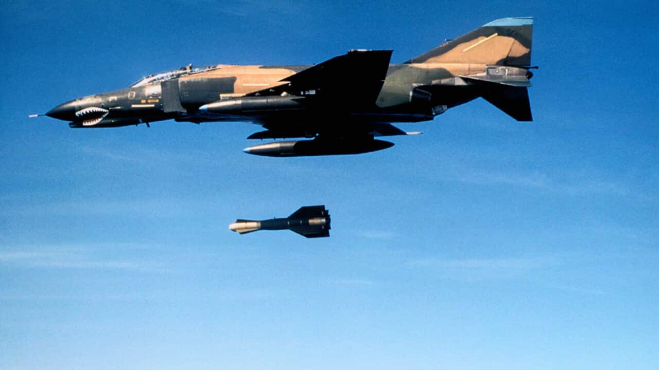 Military Aircraft Dropping a Bomb