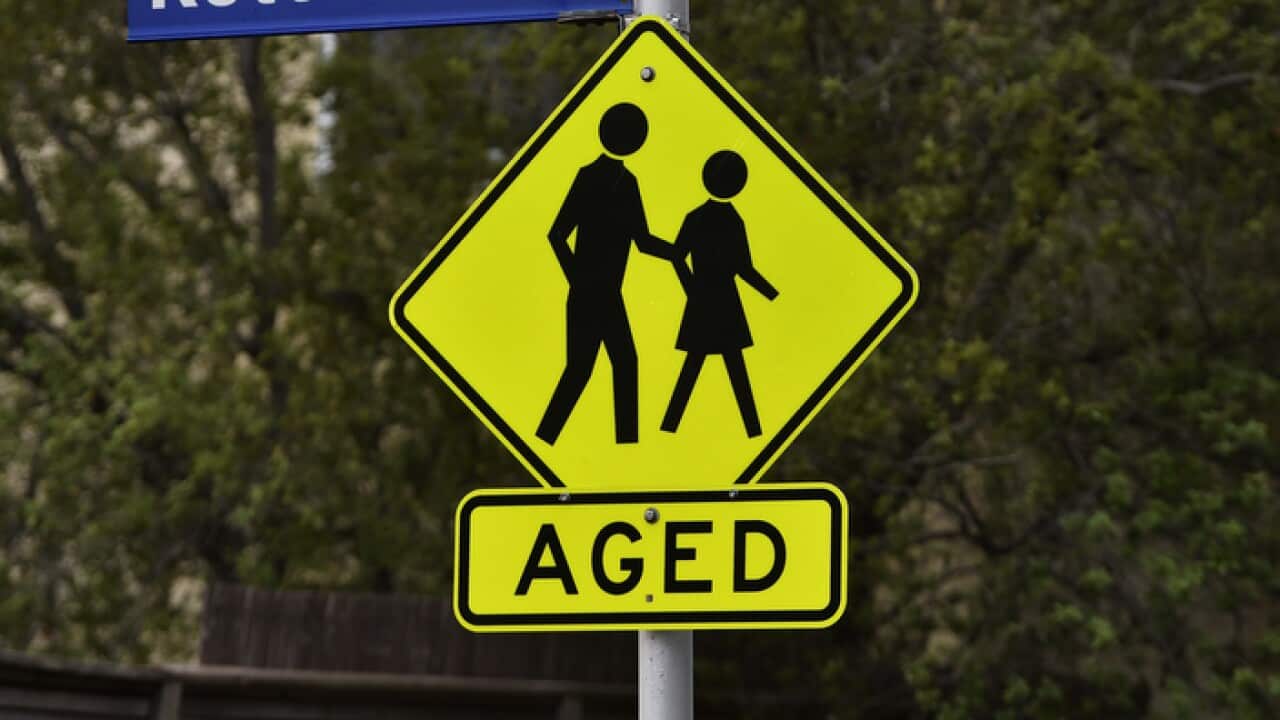 A hazard sign warning drivers of elderly members crossing the street is seen in Kensington, Melbourne, Saturday, March 30, 2019. Aged Care stock for federal budget. (AAP Image/James Ross) NO ARCHIVING