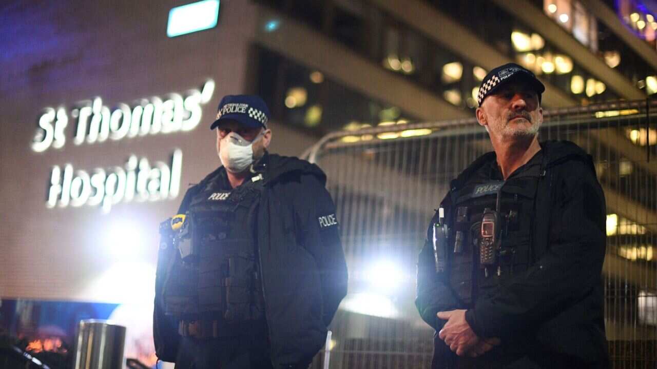 Police officers outside St Thomas' Hospital where British PM Boris Johnson is in intensive care