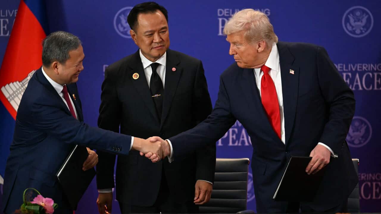 Thailand's Prime Minister Anutin Charnvirakul (centre) watches as Cambodia's Prime Minister Hun Manet (left) and US President Donald Trump (right) shake hands