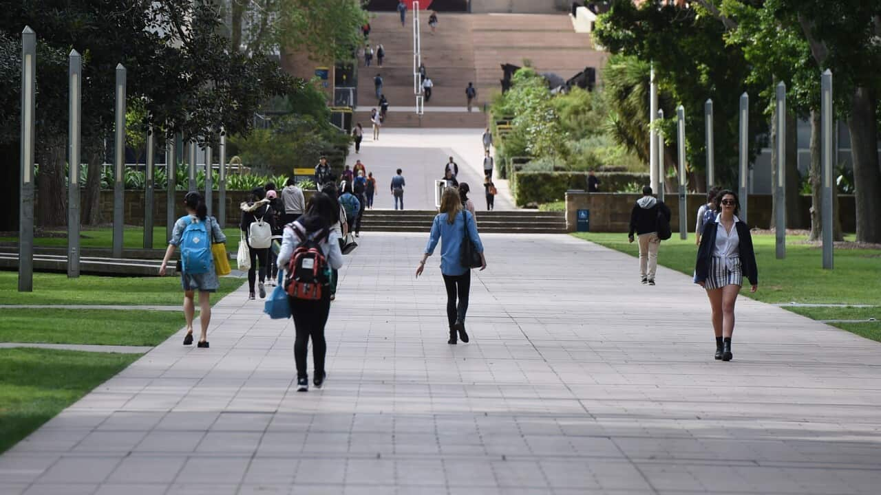 Students walking through the grounds of a university.