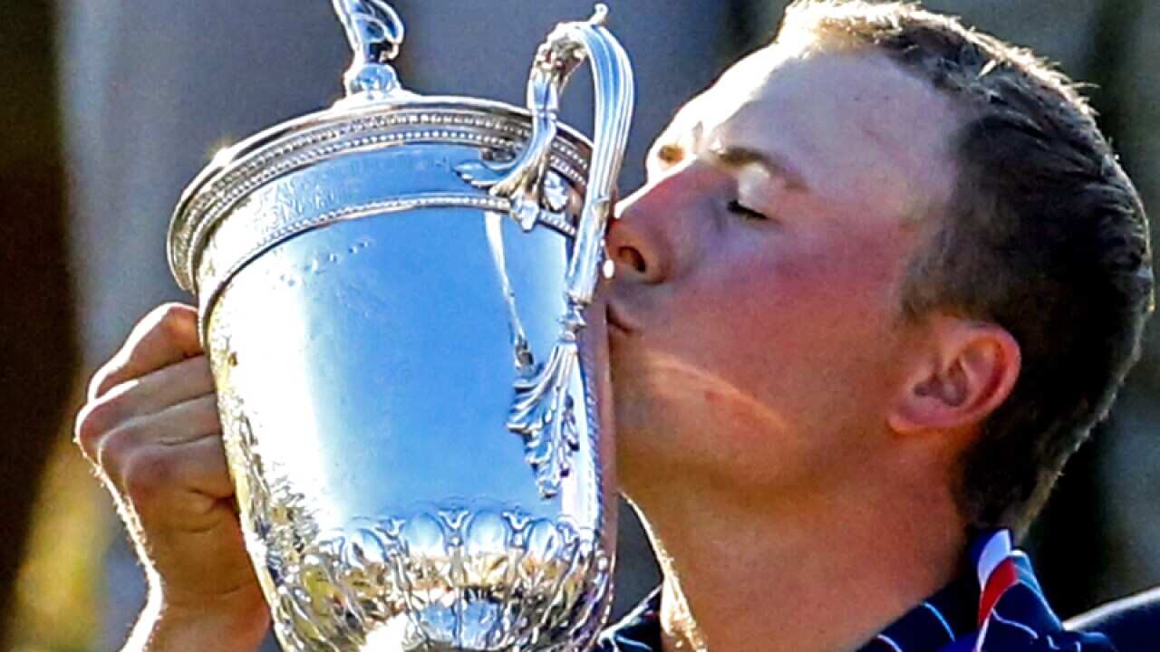 Jordan Spieth of the US kisses the Championship trophy
