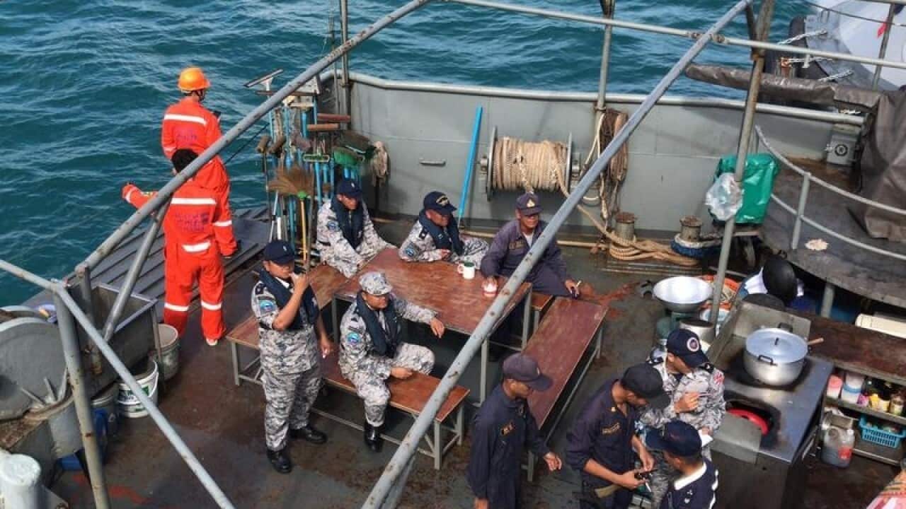 Thai rescuers are seen at a port before searching for missing tourists