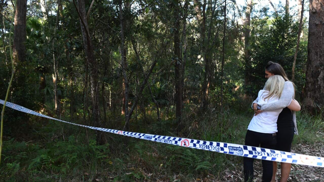 The mother of Matthew Leveson (2R) is comforted