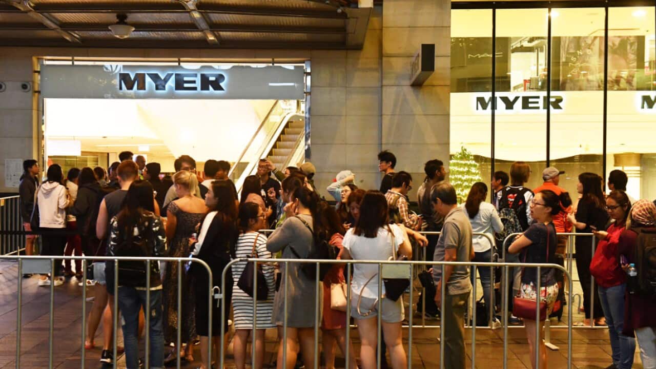 Shoppers wait outside the Myer department store for the Boxing Day sales in Sydney.