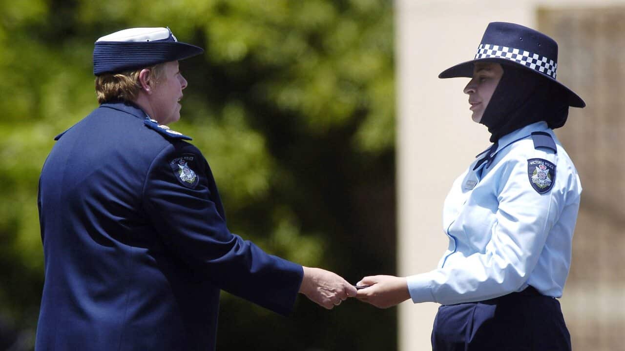 2004 - Police recruit Maha Sukkar receives her badge from Police Commissioner Christine Nixon