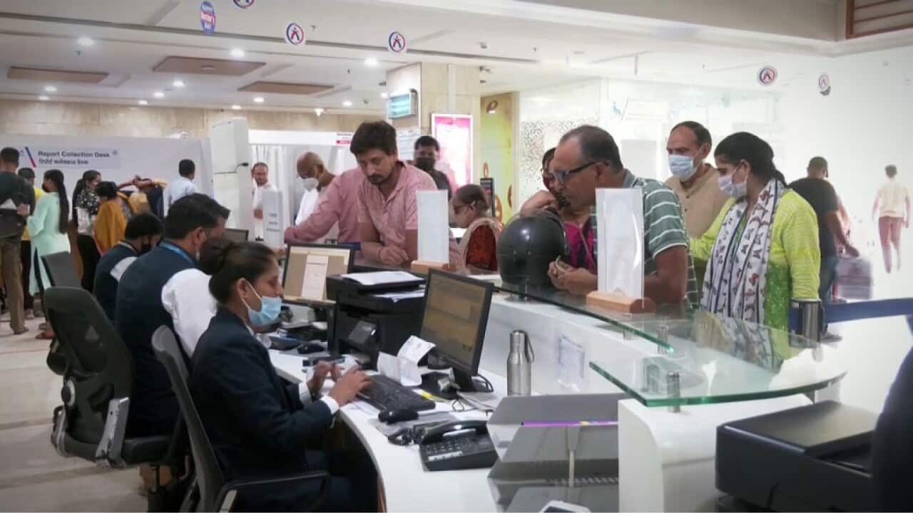 People queuing at the reception desk at the Aakash Healthcare hospital (Reuters)