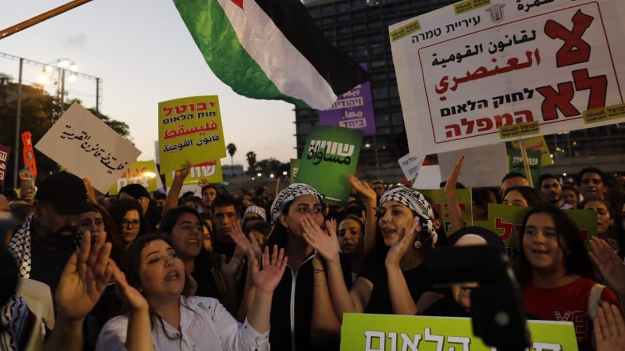 Demonstrators shout slogans as Arab Israelis and their supporters march during a rally to protest against the 'Jewish Nation-State Law' 