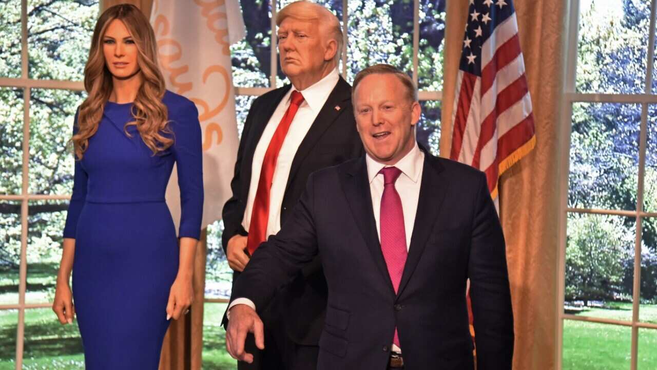 ormer White House Press Secretary Sean Spicer (R) poses next to a new wax figure of the First Lady Melania Trump flanking a figure of US President Donald Trump