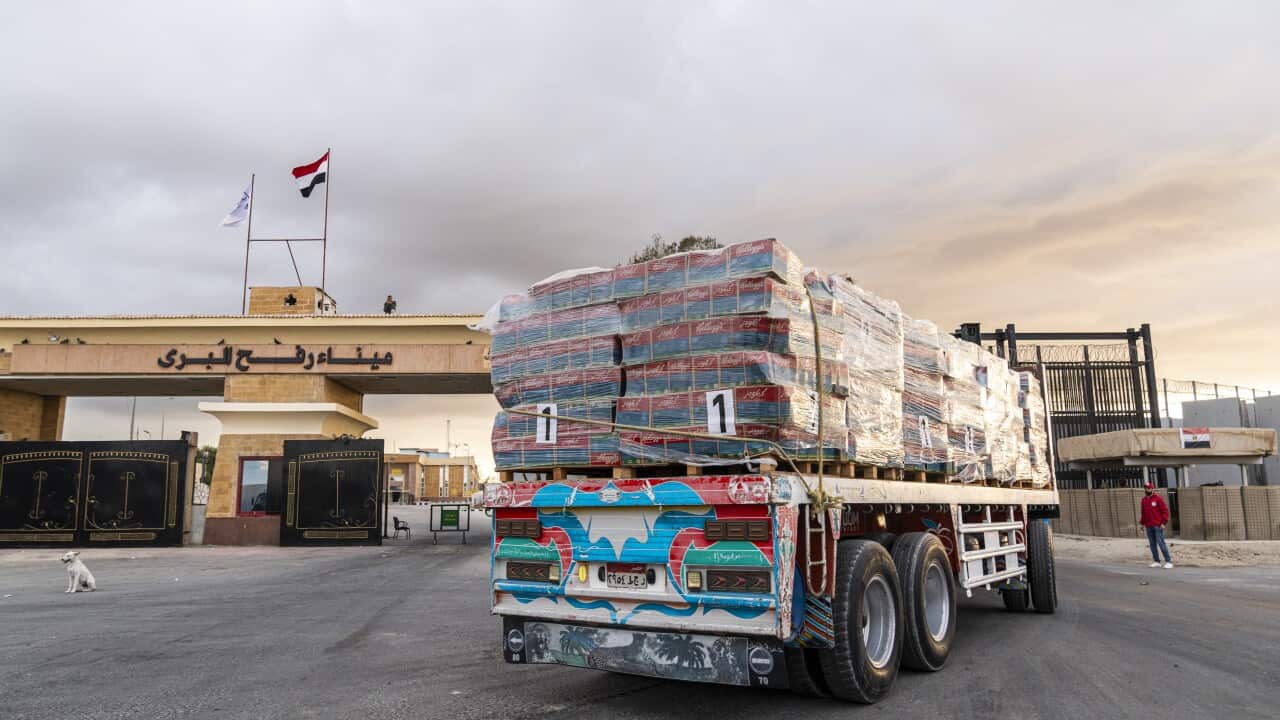 A truck with aid on it at a border crossing.