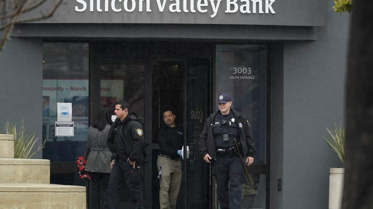 Police officers leave Silicon Valley Bank and step outside in Santa Clara