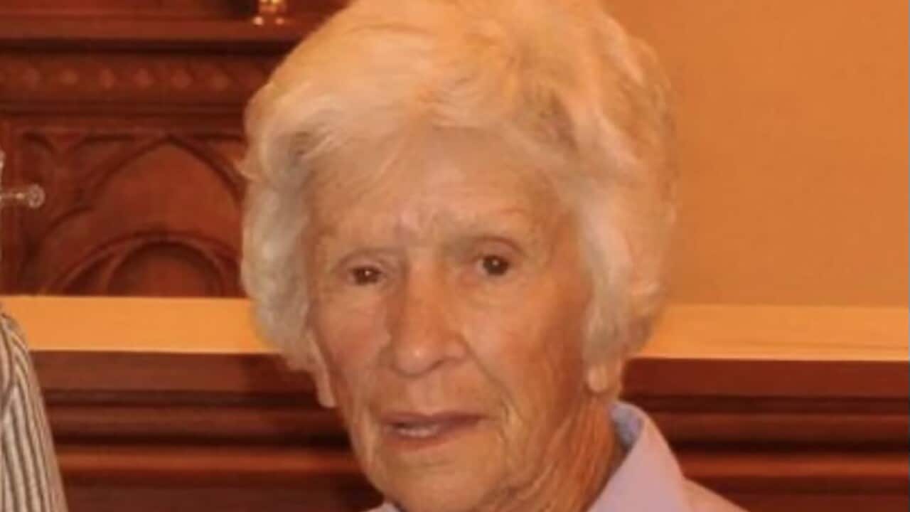 A woman in a purple collared shirt.