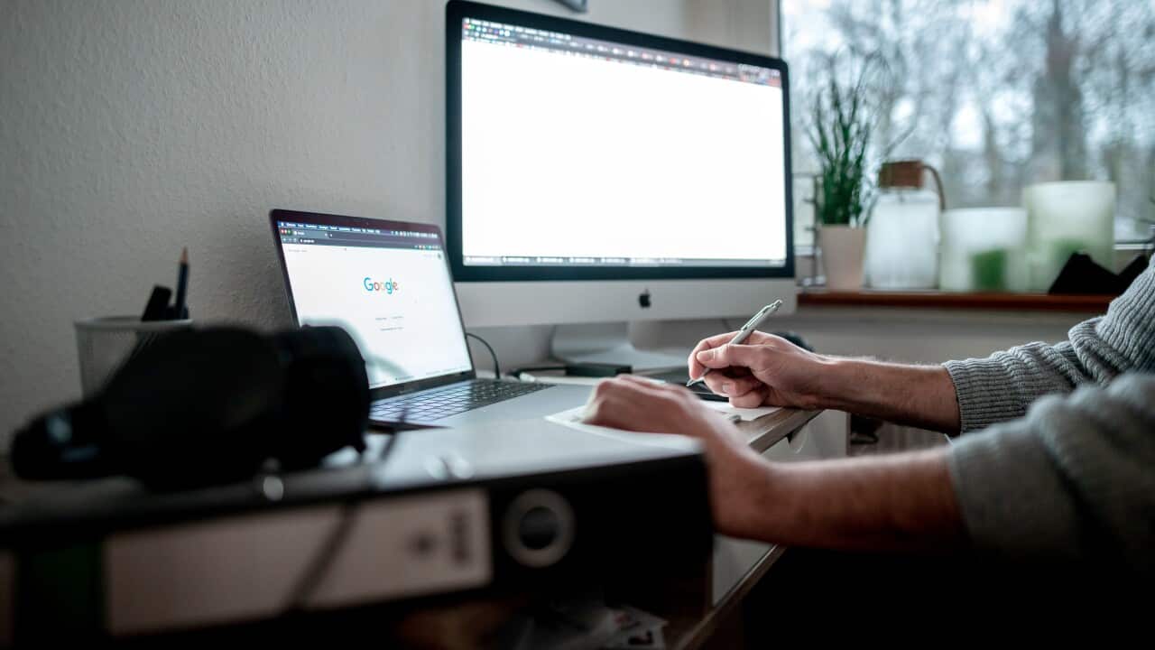 A person working at a desk in front of a window