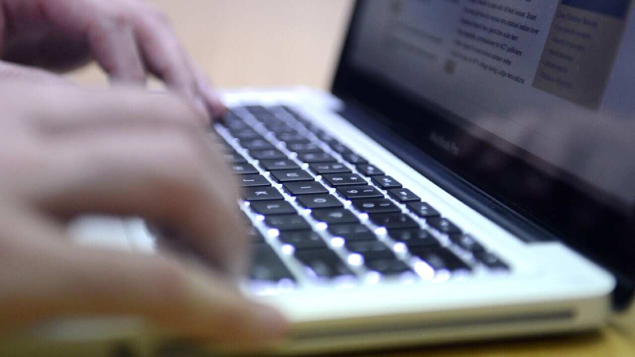 A person uses a laptop computer