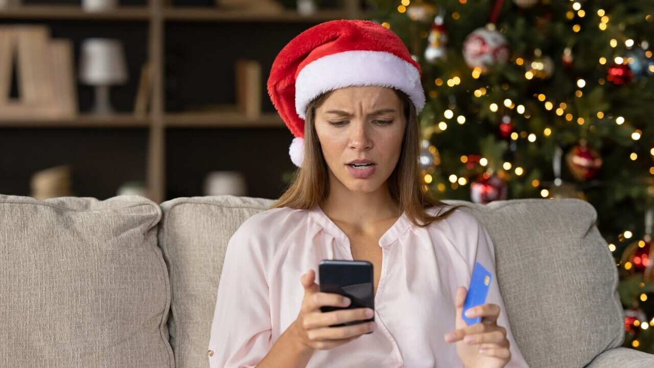 Worried concerned girl in Christmas Santa hat having problems
