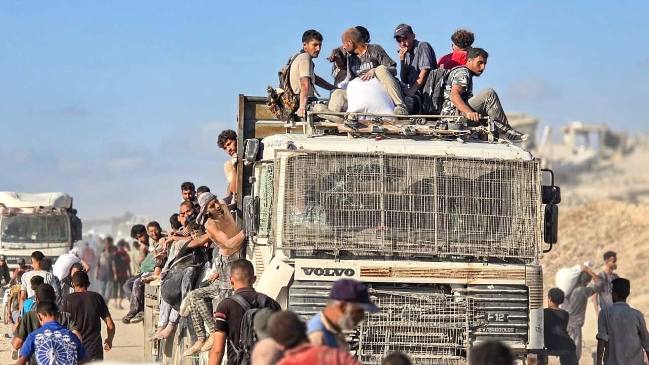 People are seen carrying bags of humanitarian aid.