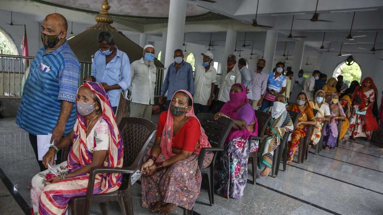 People line up to register themselves to get a dose of Covishield, Serum Institute of India's version of the AstraZeneca COVID-19 vaccine.