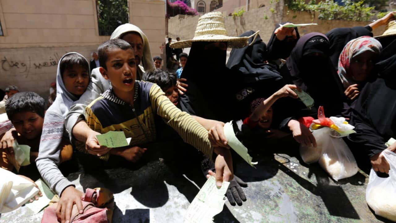 Conflict-affected Yemenis receive local charity-provided food rations in Sana'a, Yemen (AAP)