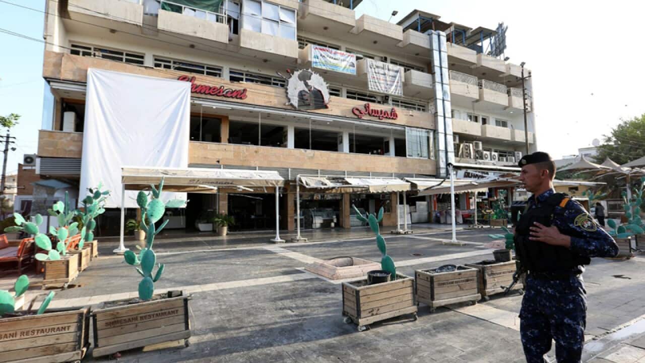 Iraqi civilians near the site of a bombing in Baghdad