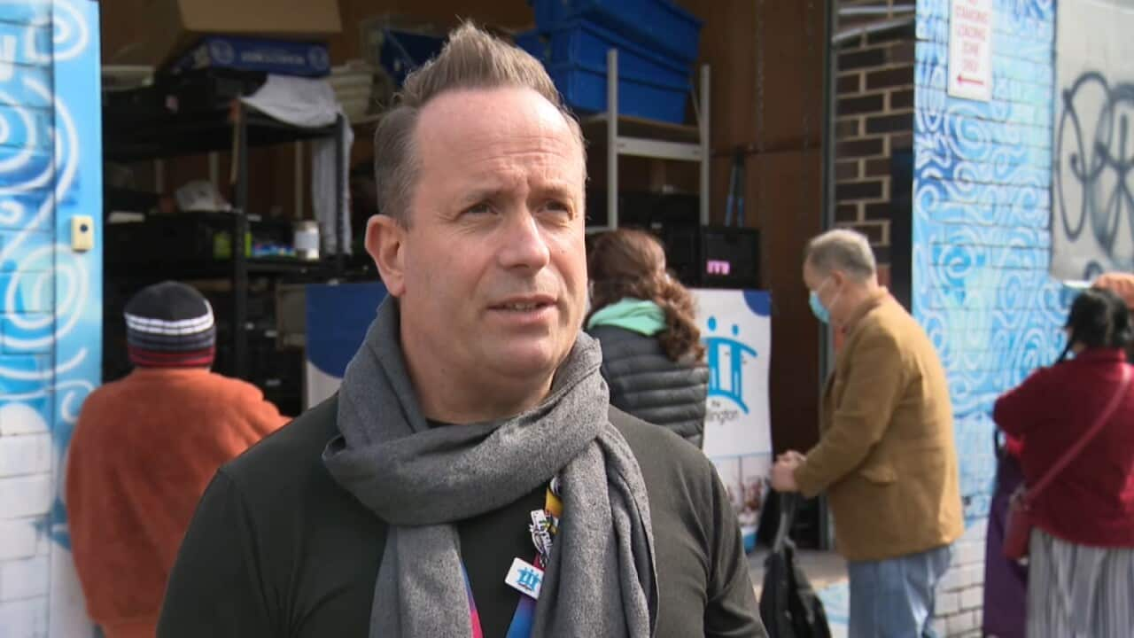 Chris Sprake stands in front of the drop-in zone where food is distributed to those in need. 