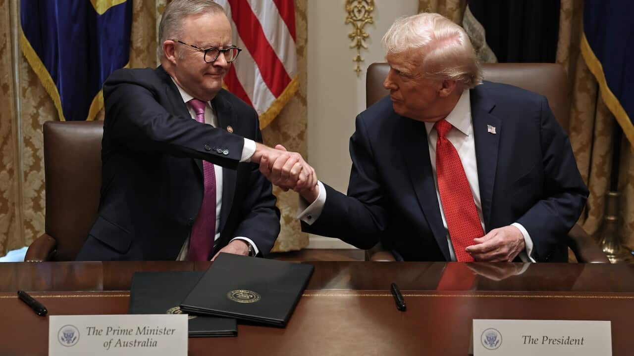 Prime Minister of Australia Anthony Albanese (L) and U.S. President Donald Trump shake hands after signing a $8.5 billion rare earth minerals agreement during a bilateral meeting in the Cabinet Room of the White House