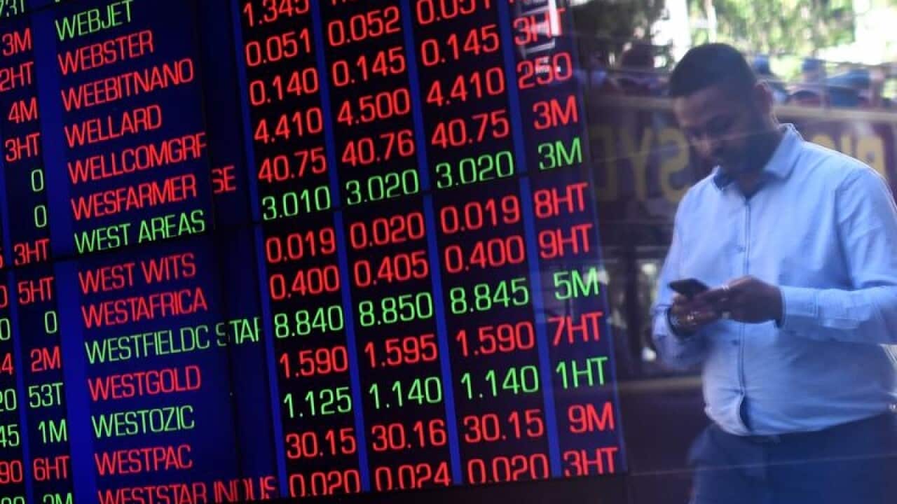 Man reflected in window near ASX board.