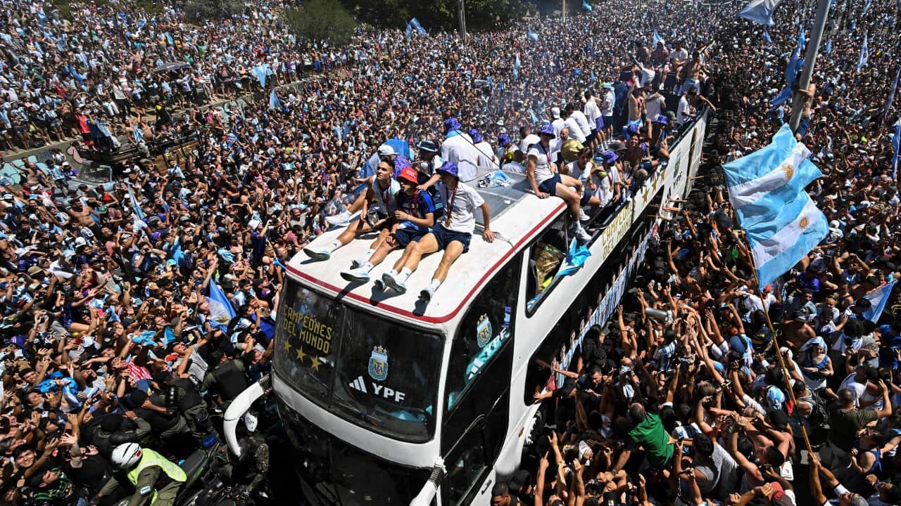 A double decker bus tried to make its way through a massive crowd of people.