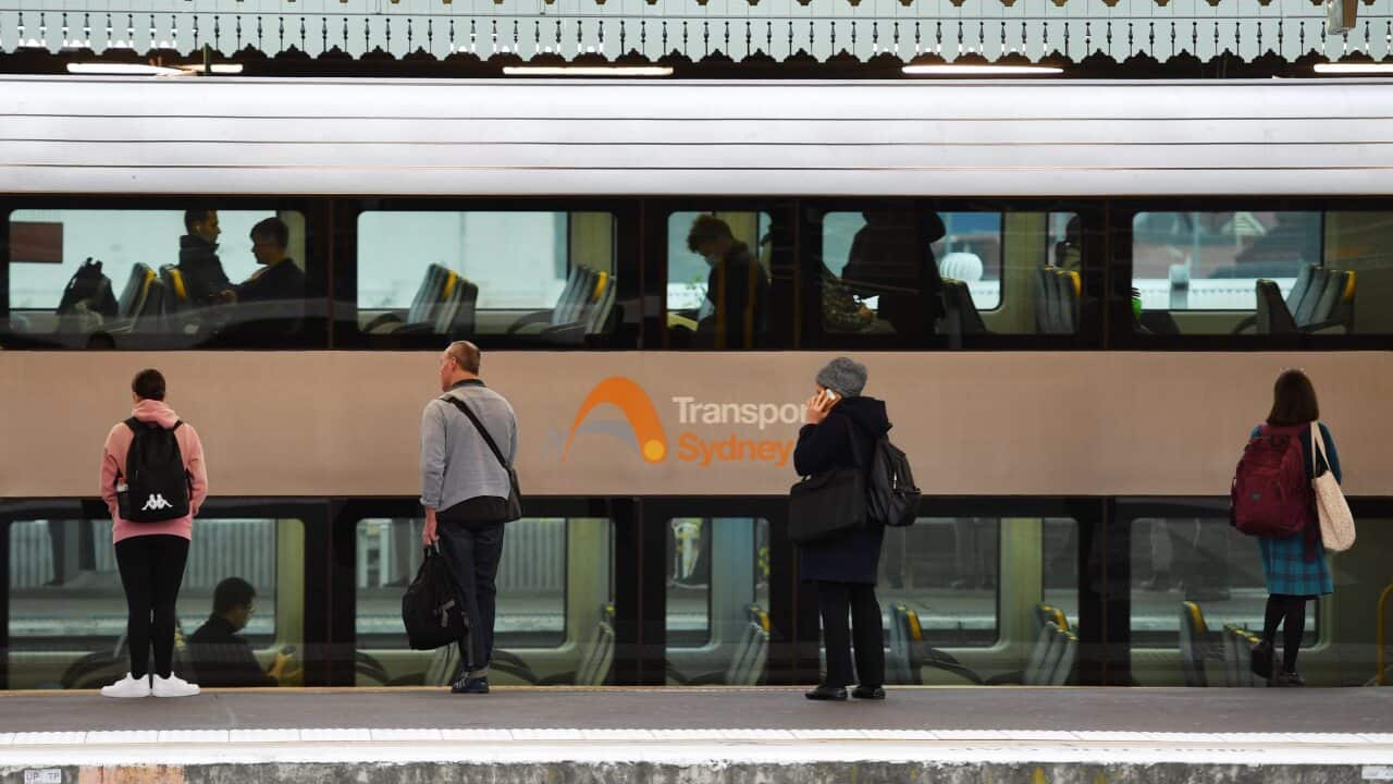 Commuters and school students return to public transport at Strathfield Train Station in Sydney on Monday.