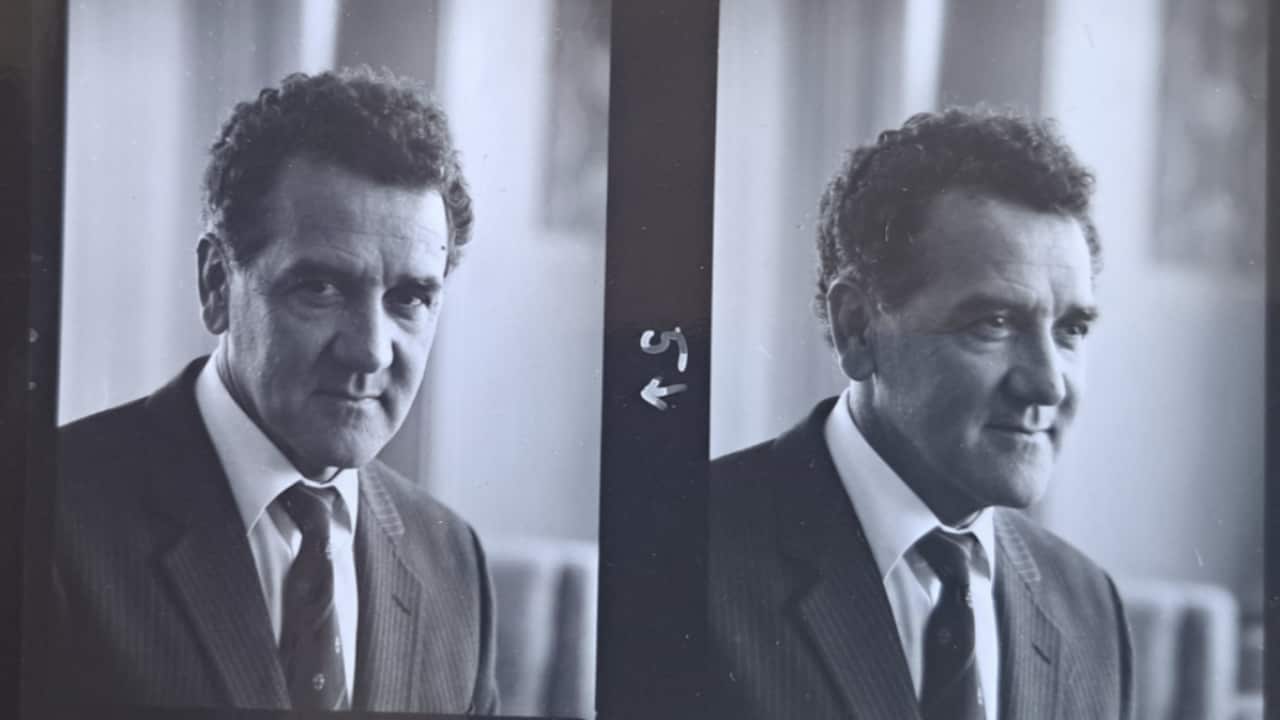 Two black-and-white images of Charles Perkins, wearing a suit.