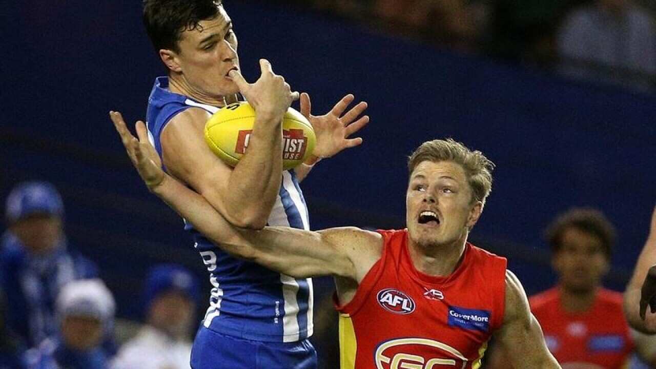 North Melbourne Kangaroos player Scott Thompson (L)