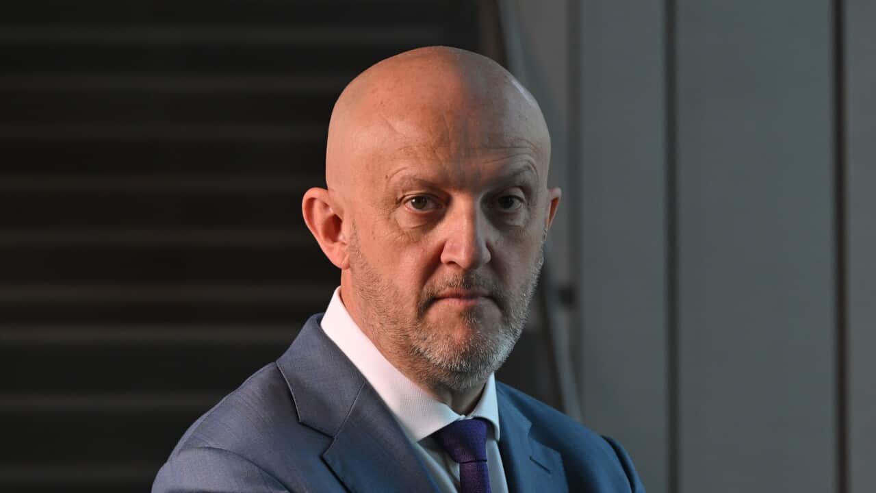 ASIO head Mike Burgess staring into camera.