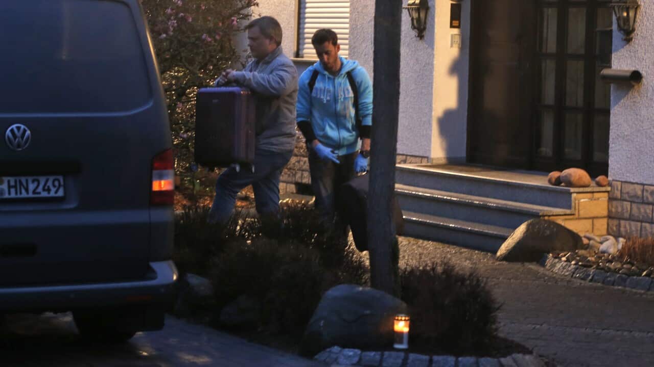 Investigators carry a suitcase out of the home of the family of Andreas Lubitz in Montabaur, Germany, Thursday, March 26, 2015. Lubitz was the copilot on flight Germanwings 9525 that crashed with 150 people on board on Tuesday in the French Alps.