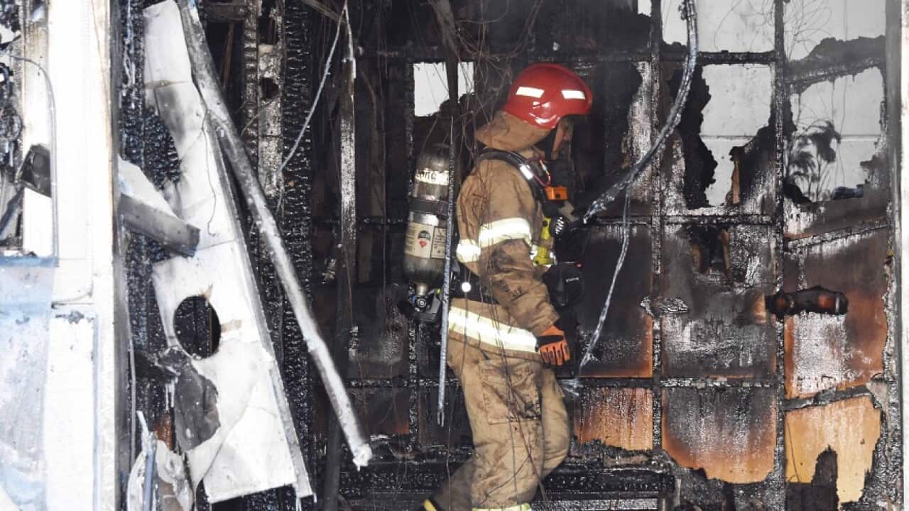 A firefighter operating on the scene after a fire at a hospital in Miryang, South Korea, 26 January 2018.