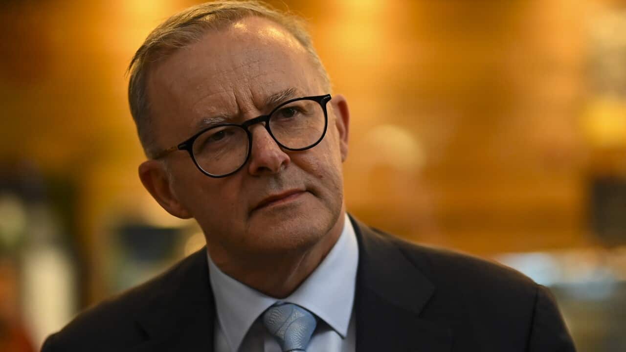 A man with a neutral facial expression