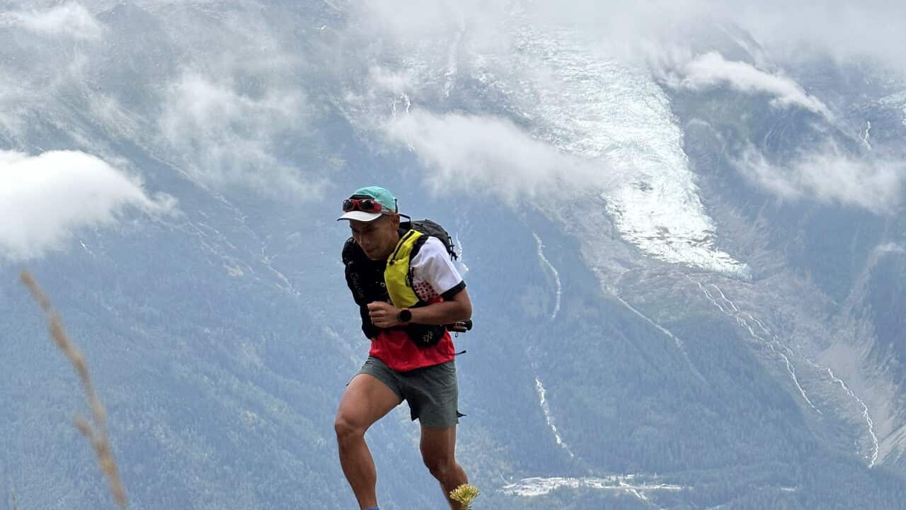 Fandhi Achmad hiking on top of a mountain