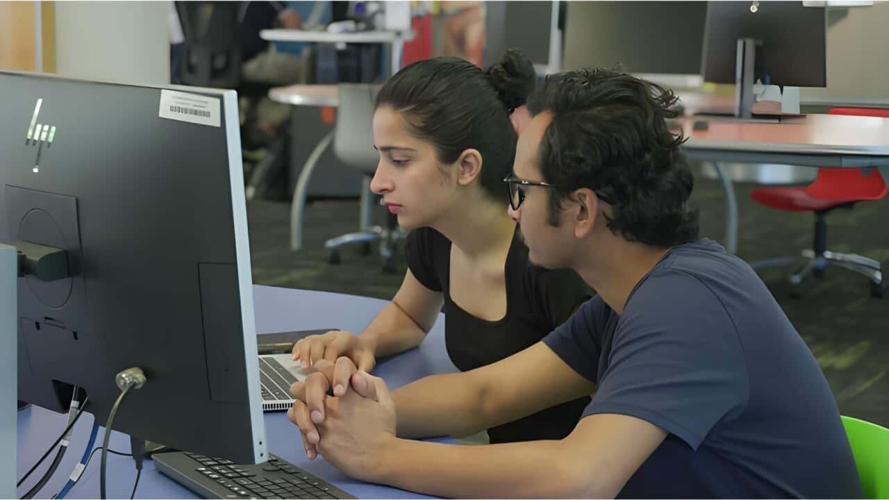 Madhu Regmi (L) and Yuvraj Pokhrel working at University (SBS).jpg