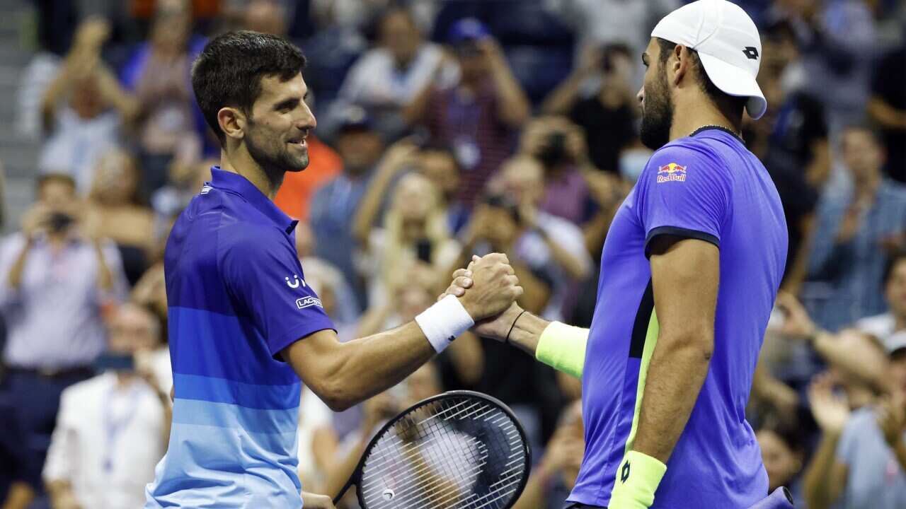 Novak Djokovic of Serbia (L) shakes hands with Matteo Berrettini of Italy after defeating him during their quarterfinals round match on the tenth day of the US Open Tennis Championships at the USTA National Tennis Center in Flushing Meadows, New York, USA